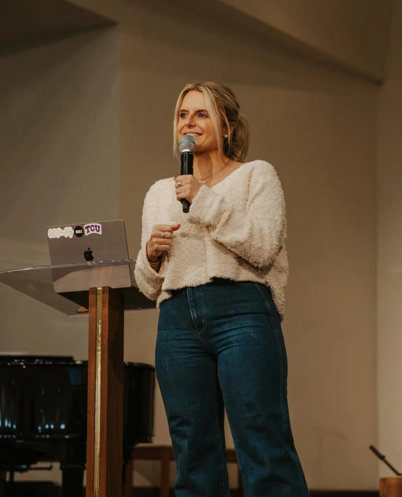 Teryl speaking under a real church arch, cropped inside the brand arch